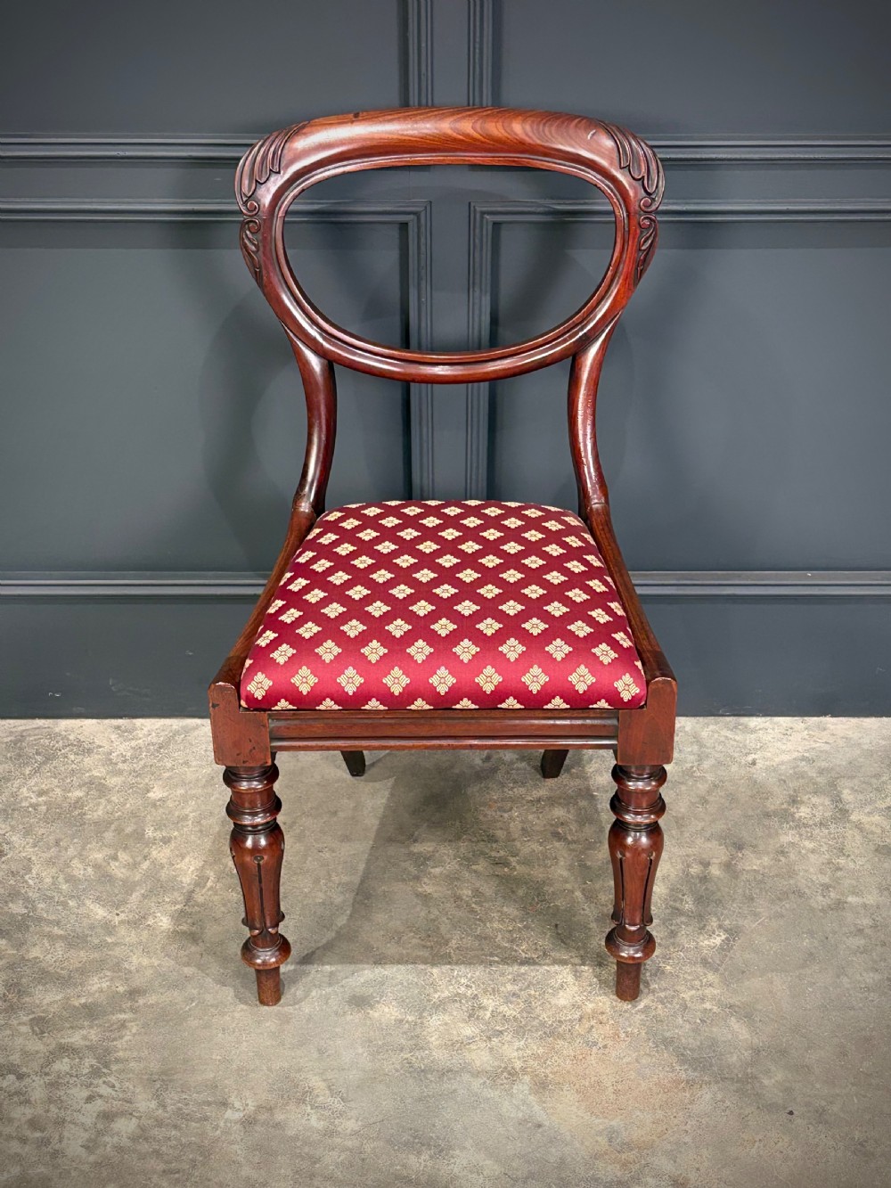 A pair of Victorian mahogany side chairs with rounded balloon backs, turned front legs, and red patterned fabric seats. View VIII