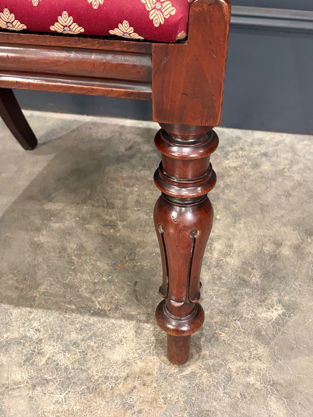 A pair of Victorian mahogany side chairs with rounded balloon backs, turned front legs, and red patterned fabric seats. View IX
