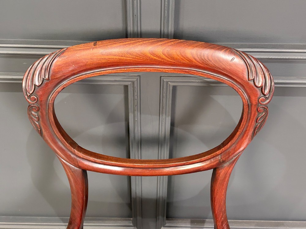 A pair of Victorian mahogany side chairs with rounded balloon backs, turned front legs, and red patterned fabric seats. View X