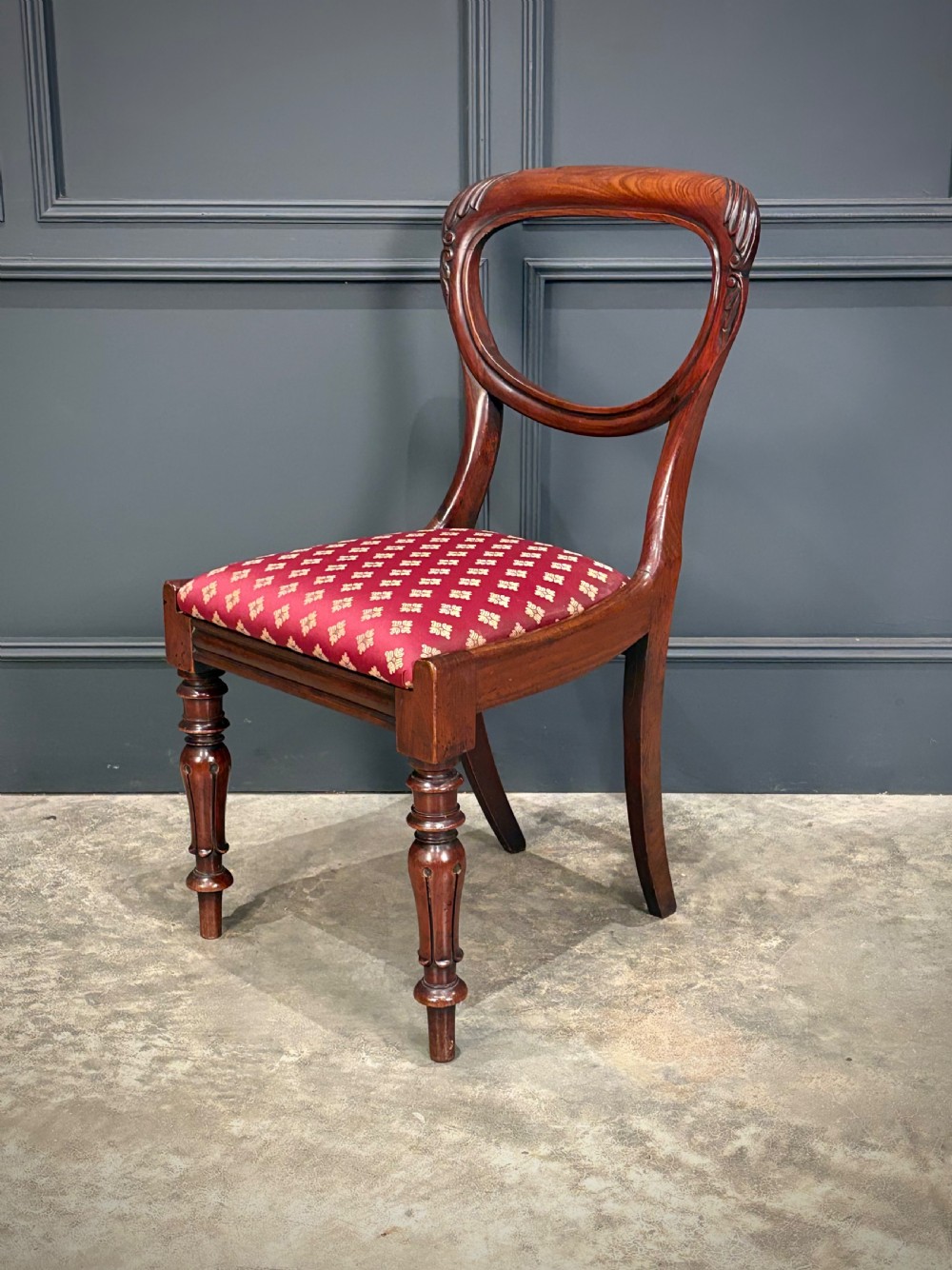 A pair of Victorian mahogany side chairs with rounded balloon backs, turned front legs, and red patterned fabric seats. View XII