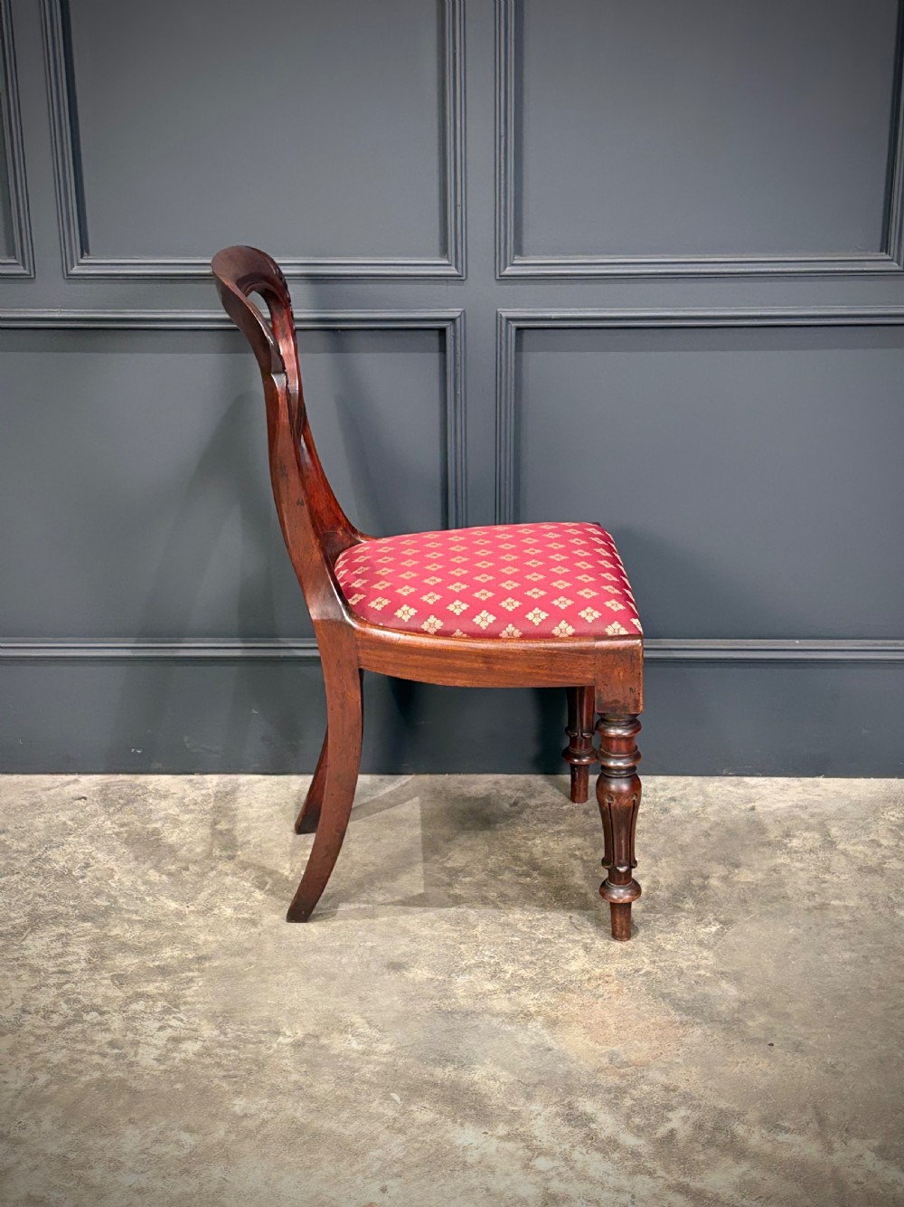 A pair of Victorian mahogany side chairs with rounded balloon backs, turned front legs, and red patterned fabric seats. View XV