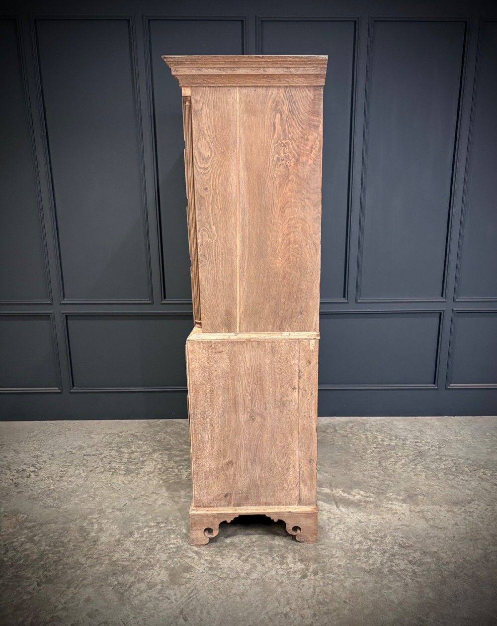 A Georgian bleached oak chest on chest featuring a two-part stacked design with brass drop handles and bracket feet. View V