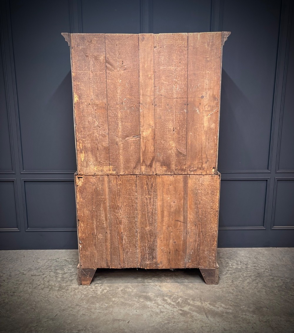 A Georgian bleached oak chest on chest featuring a two-part stacked design with brass drop handles and bracket feet. View VI