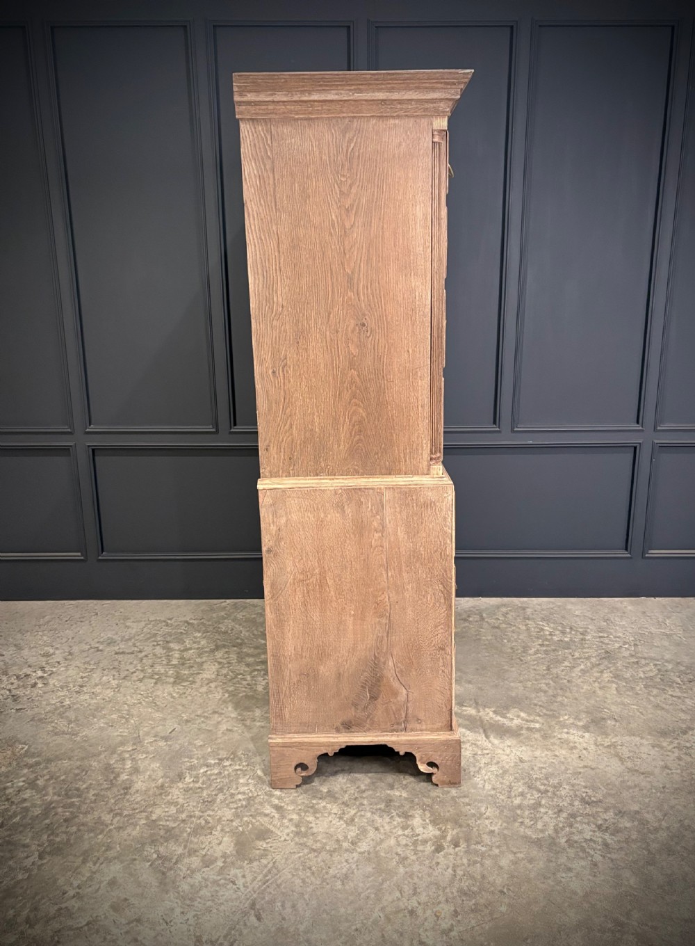 A Georgian bleached oak chest on chest featuring a two-part stacked design with brass drop handles and bracket feet. View VII