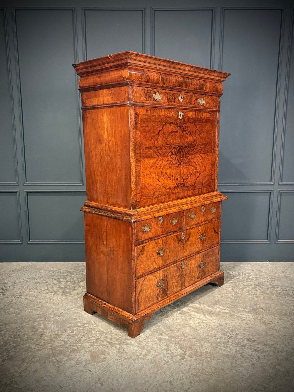 An antique Queen Anne walnut escritoire featuring a drop-front writing surface revealing a fitted interior above a base with drawers. View II