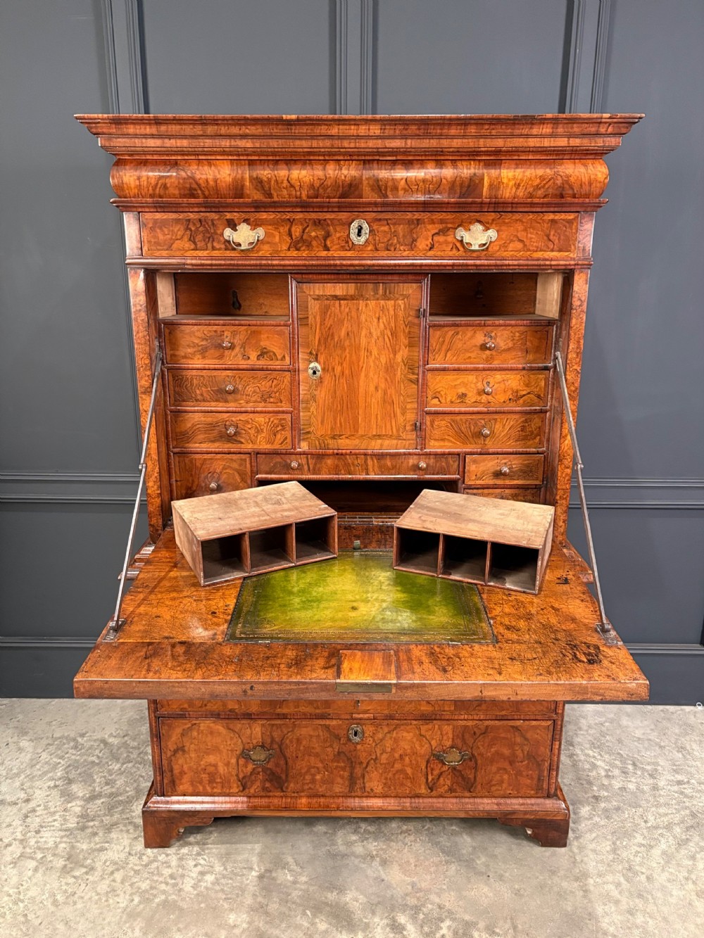 An antique Queen Anne walnut escritoire featuring a drop-front writing surface revealing a fitted interior above a base with drawers. View VI