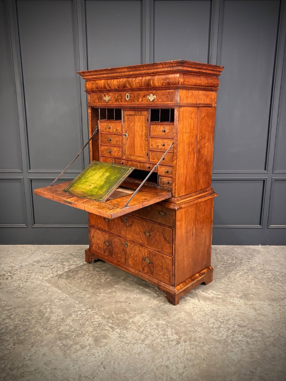 An antique Queen Anne walnut escritoire featuring a drop-front writing surface revealing a fitted interior above a base with drawers. View VIII