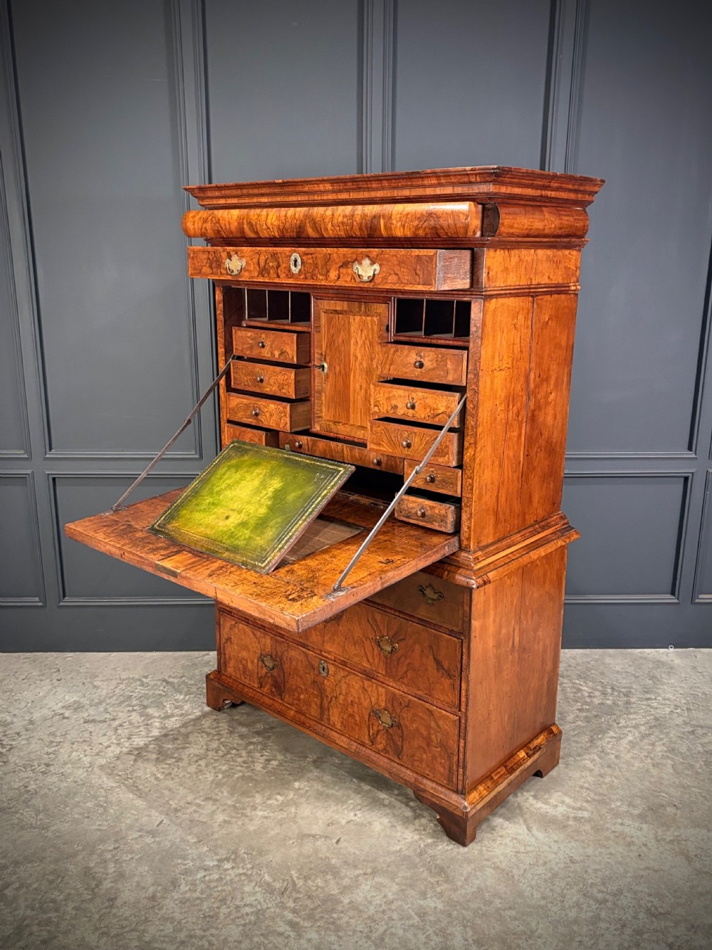 An antique Queen Anne walnut escritoire featuring a drop-front writing surface revealing a fitted interior above a base with drawers. View IX