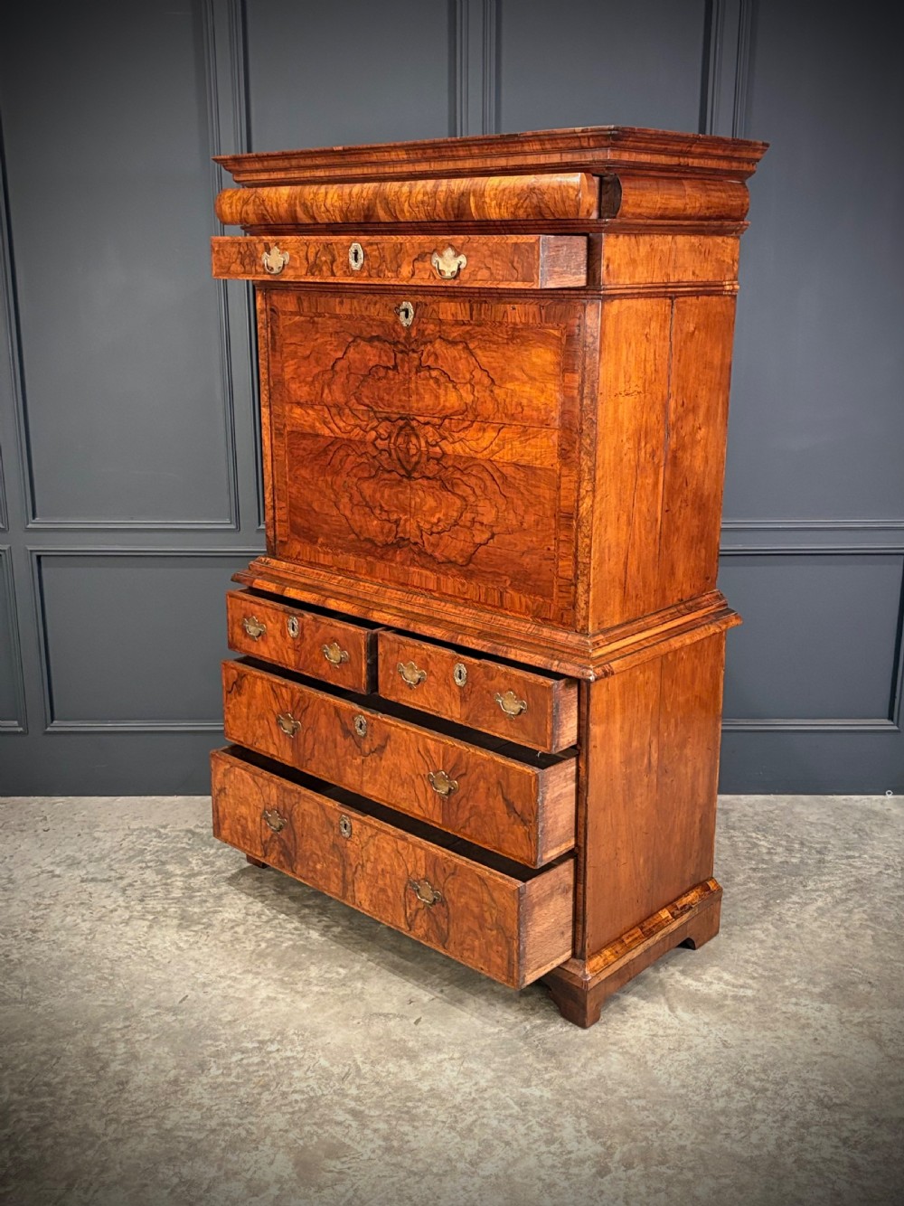 An antique Queen Anne walnut escritoire featuring a drop-front writing surface revealing a fitted interior above a base with drawers. View XII