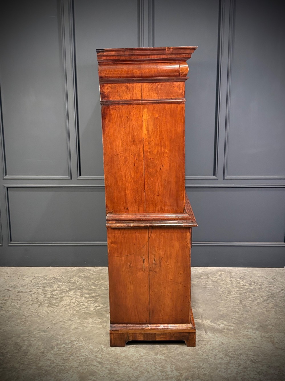 An antique Queen Anne walnut escritoire featuring a drop-front writing surface revealing a fitted interior above a base with drawers. View XV