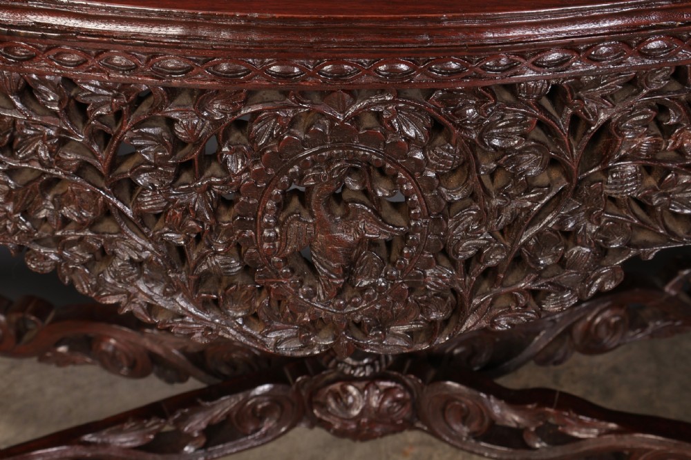 A carved dark padauk wood console table featuring openwork floral fretwork, a raised gallery back, and carved cabriole legs. View VI