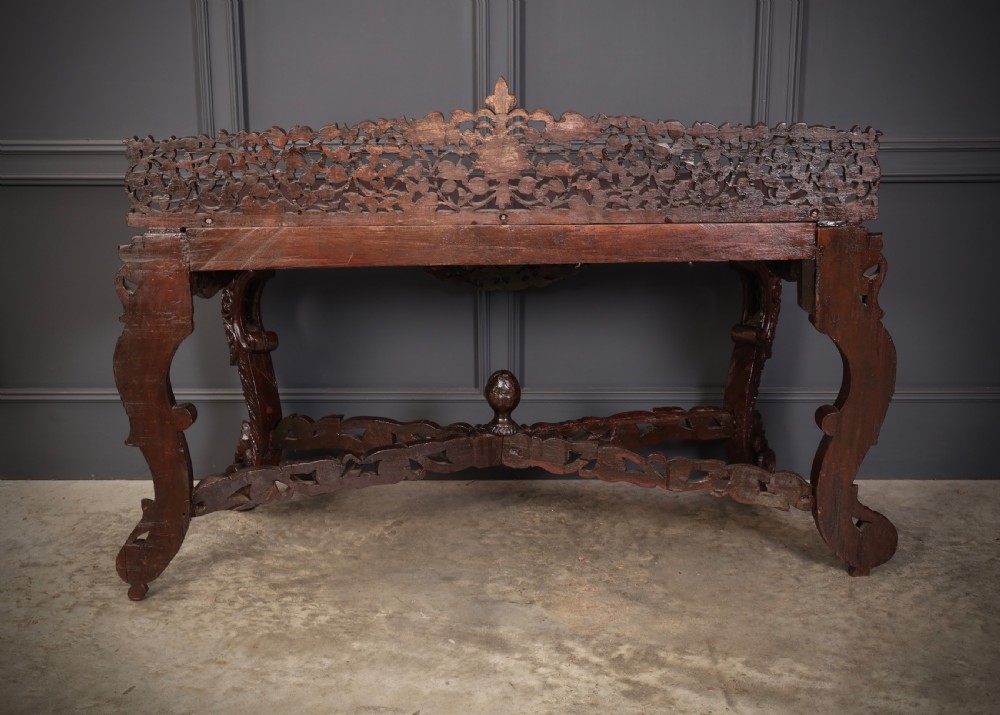 A carved dark padauk wood console table featuring openwork floral fretwork, a raised gallery back, and carved cabriole legs. View XI