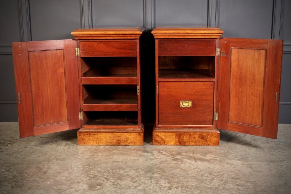 A matching pair of Victorian figured walnut pedestal cabinets featuring carved corbels, panelled doors with decorative line inlay, and sturdy plinth bases. View IV
