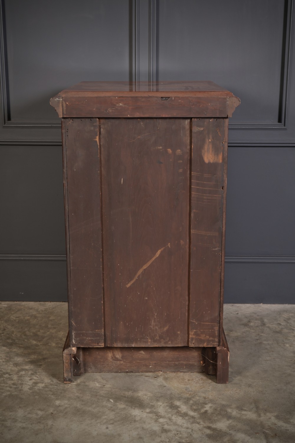 A matching pair of Victorian figured walnut pedestal cabinets featuring carved corbels, panelled doors with decorative line inlay, and sturdy plinth bases. View XII