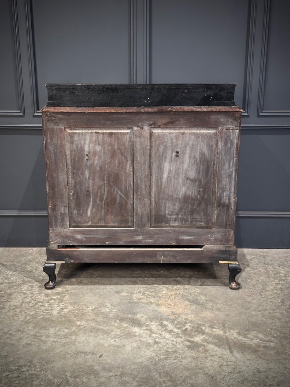 A black lacquered side cabinet decorated with gold chinoiserie landscape scenes, featuring one top drawer, double doors, and cabriole legs. View XII