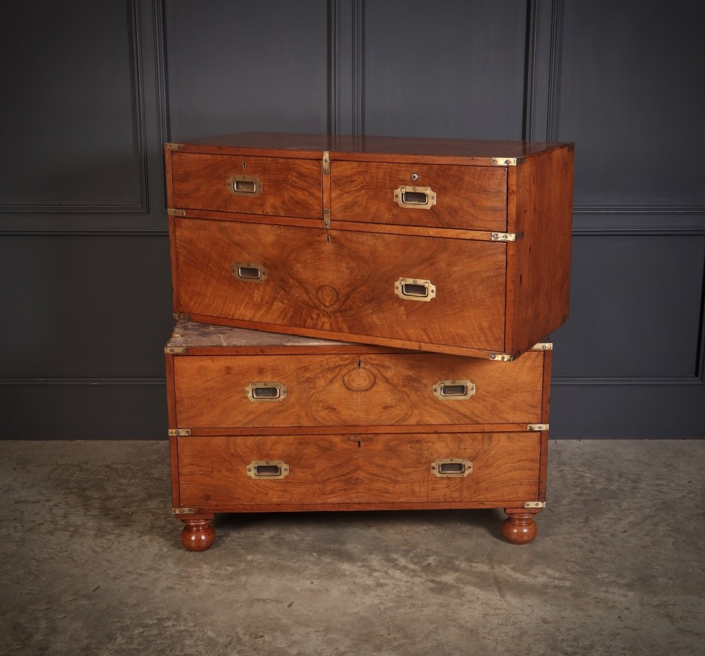 A Victorian figured walnut military campaign chest featuring two stackable sections, flush brass handles, brass corner strapping, and turned feet. View XIII