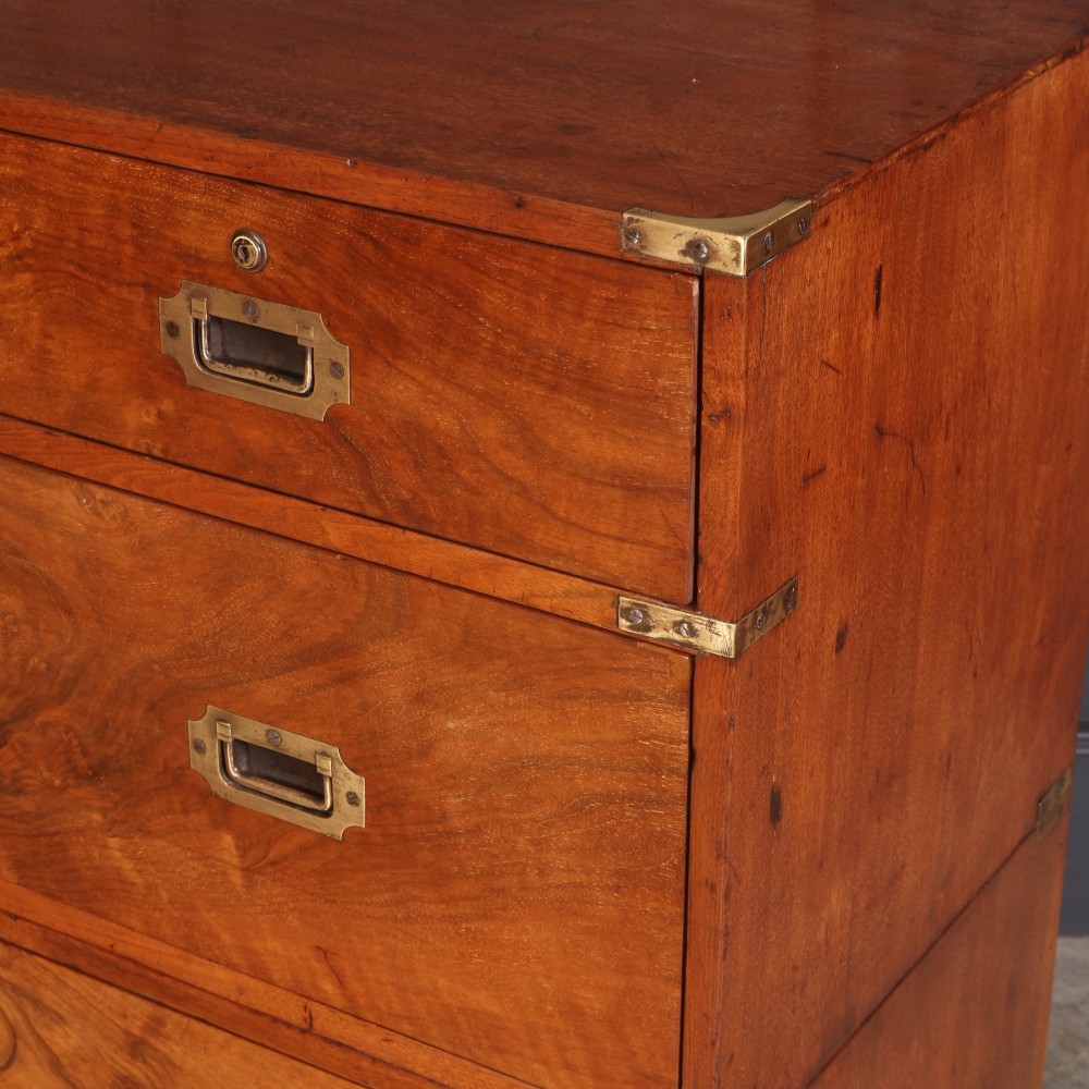A Victorian figured walnut military campaign chest featuring two stackable sections, flush brass handles, brass corner strapping, and turned feet. View XIV