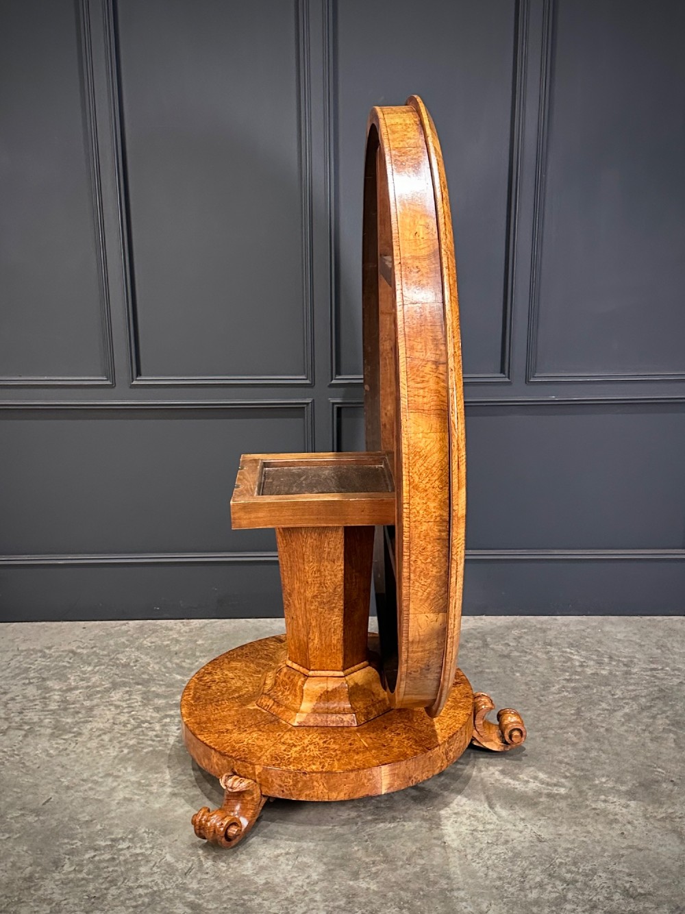 A round antique pollard oak breakfast table featuring a radial veneer pattern, faceted pedestal column, platform base, and four scroll feet. View IX