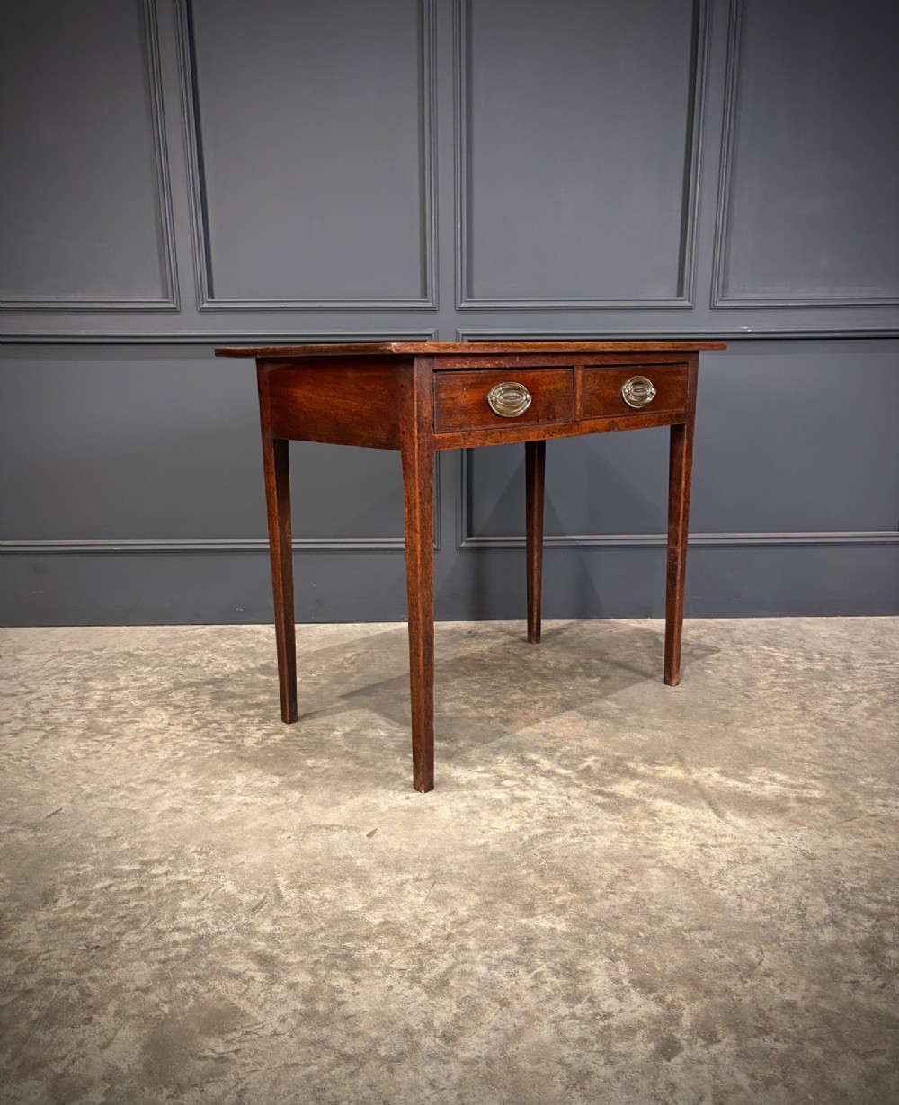A Georgian mahogany side table featuring two front drawers with oval brass handles and straight square tapered legs. View III