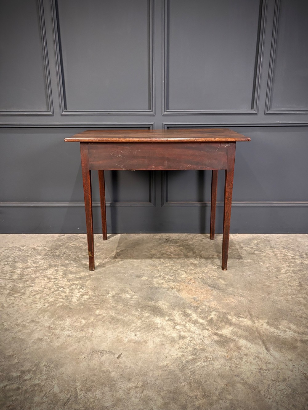 A Georgian mahogany side table featuring two front drawers with oval brass handles and straight square tapered legs. View IX