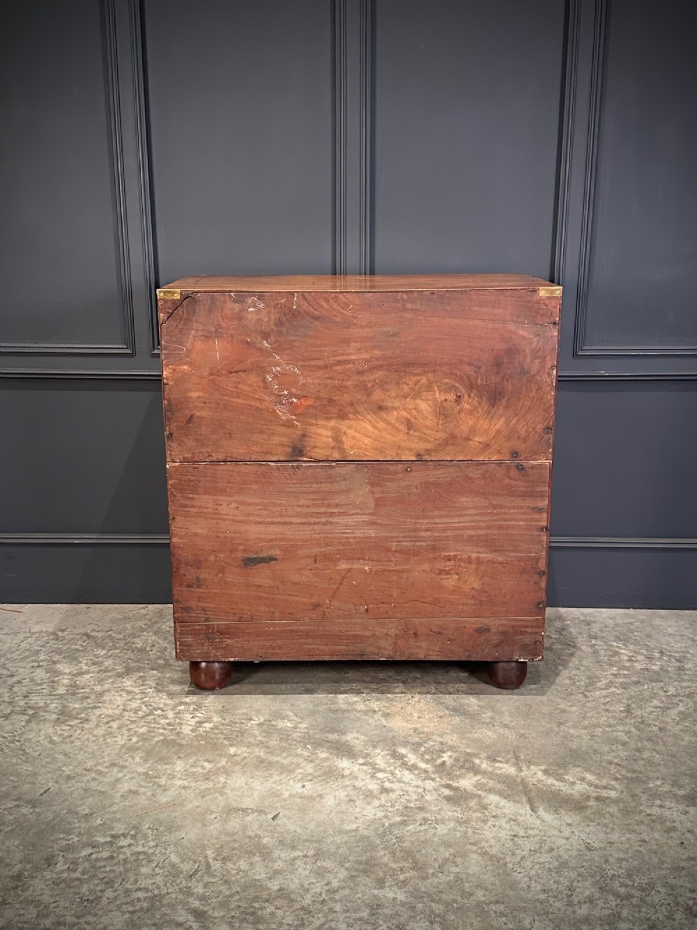 A Victorian two-part mahogany military campaign chest featuring flush brass handles, brass corner mounts, and turned bun feet. View X