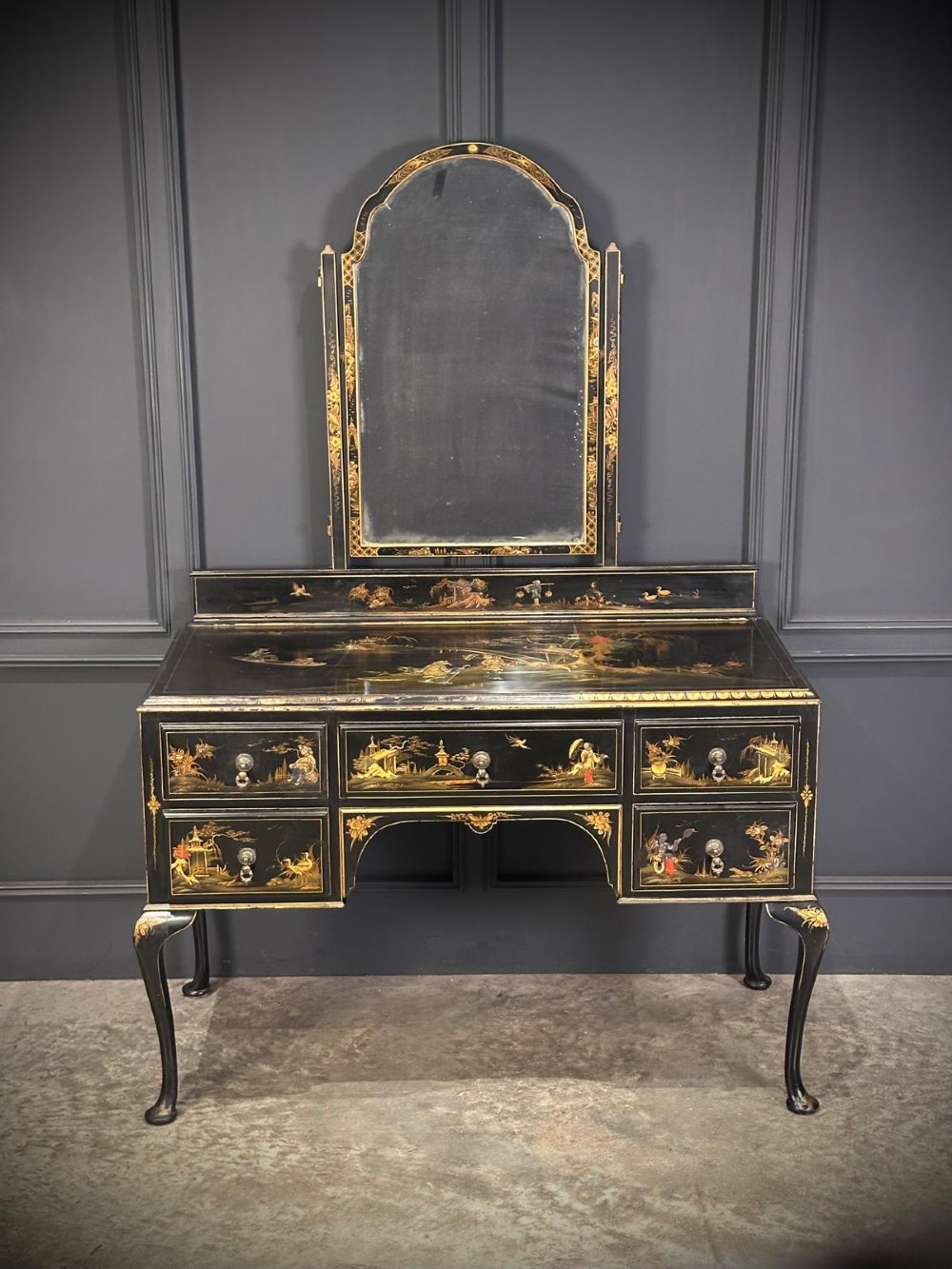 A black lacquered Chinoiserie dressing table featuring gilt hand-painted figures and landscapes, five drawers, cabriole legs, and an arched mirror attached to the top. View III