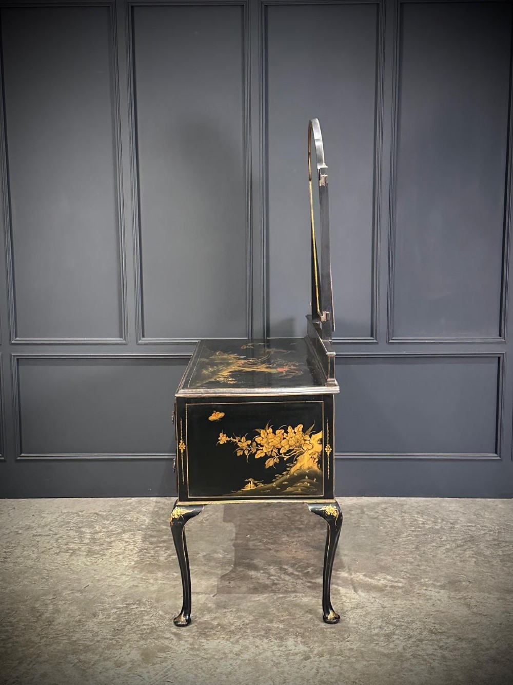 A black lacquered Chinoiserie dressing table featuring gilt hand-painted figures and landscapes, five drawers, cabriole legs, and an arched mirror attached to the top. View IV