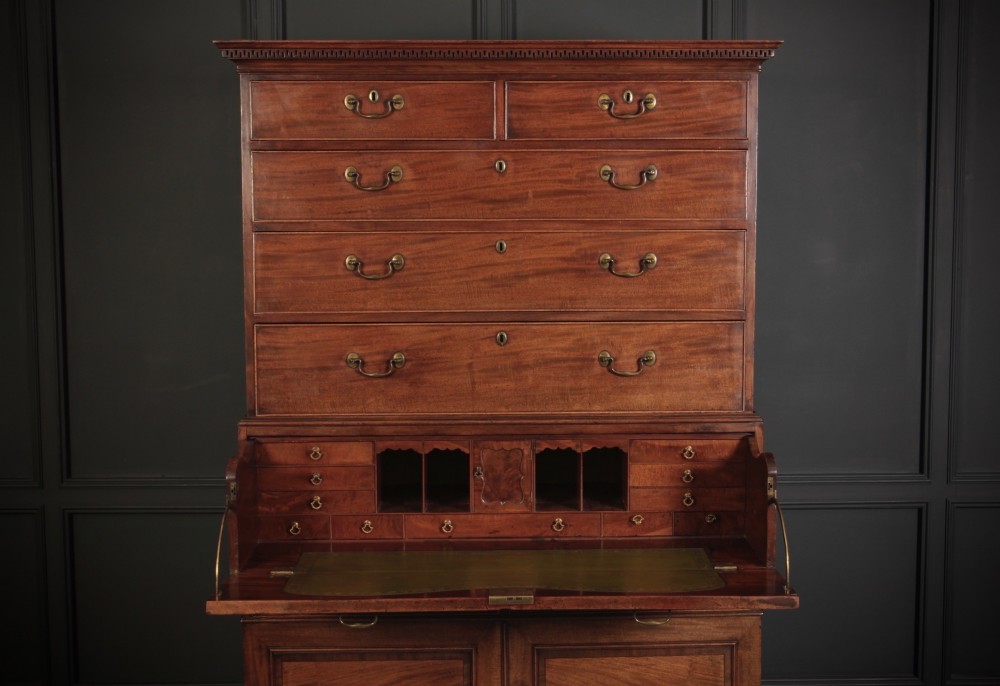 An 18th-century Georgian flame mahogany tallboy chest on chest featuring brass handles, upper drawers, and lower cupboard doors. View III