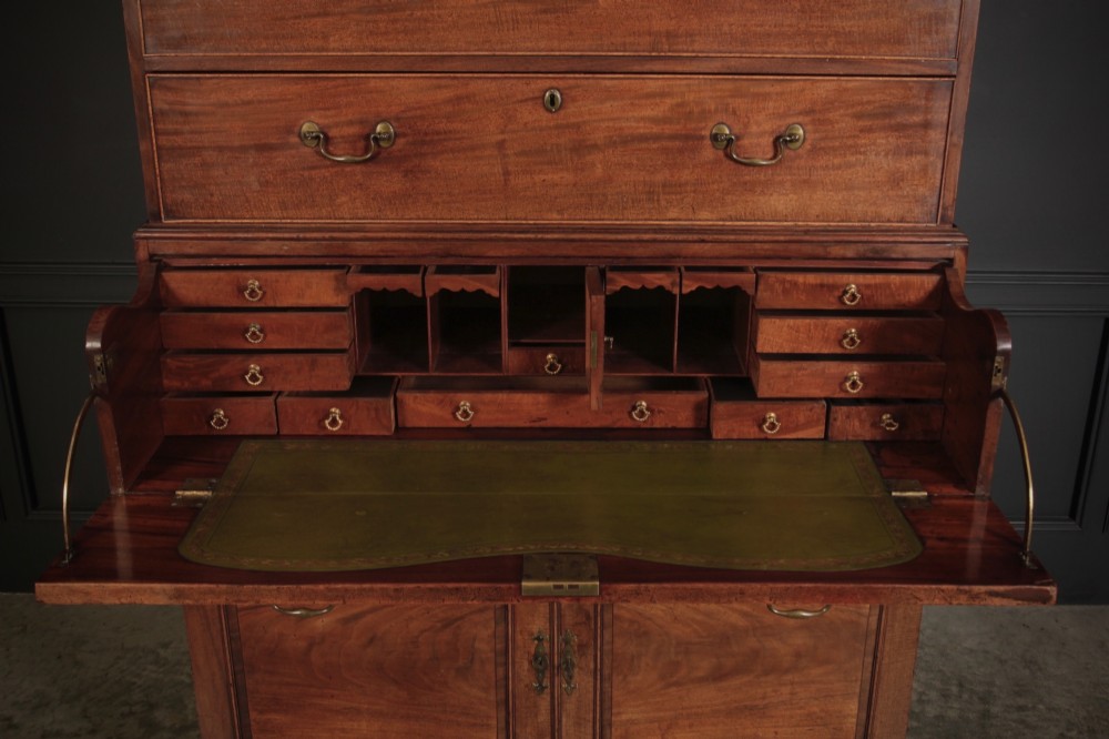 An 18th-century Georgian flame mahogany tallboy chest on chest featuring brass handles, upper drawers, and lower cupboard doors. View V