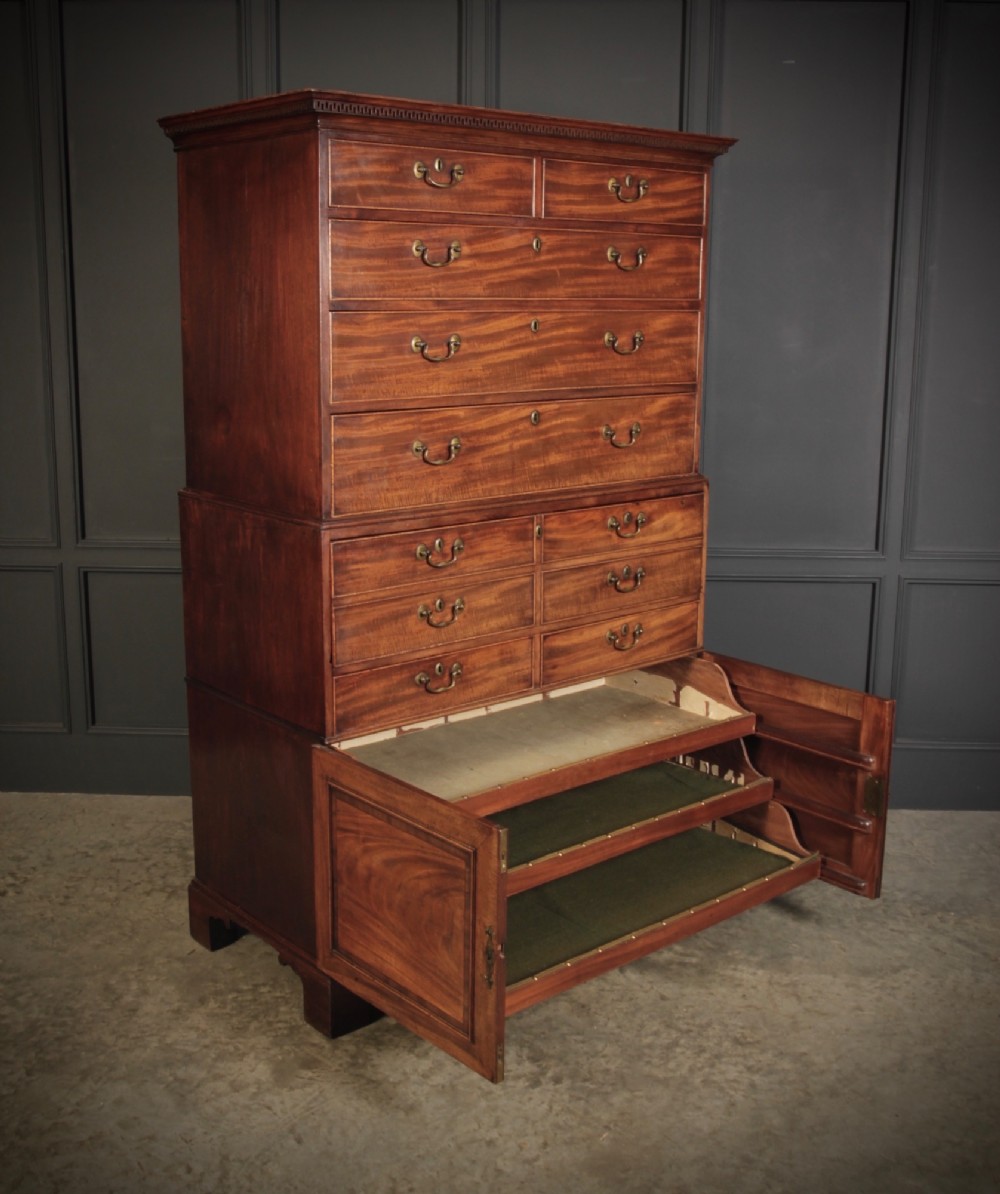 An 18th-century Georgian flame mahogany tallboy chest on chest featuring brass handles, upper drawers, and lower cupboard doors. View VIII