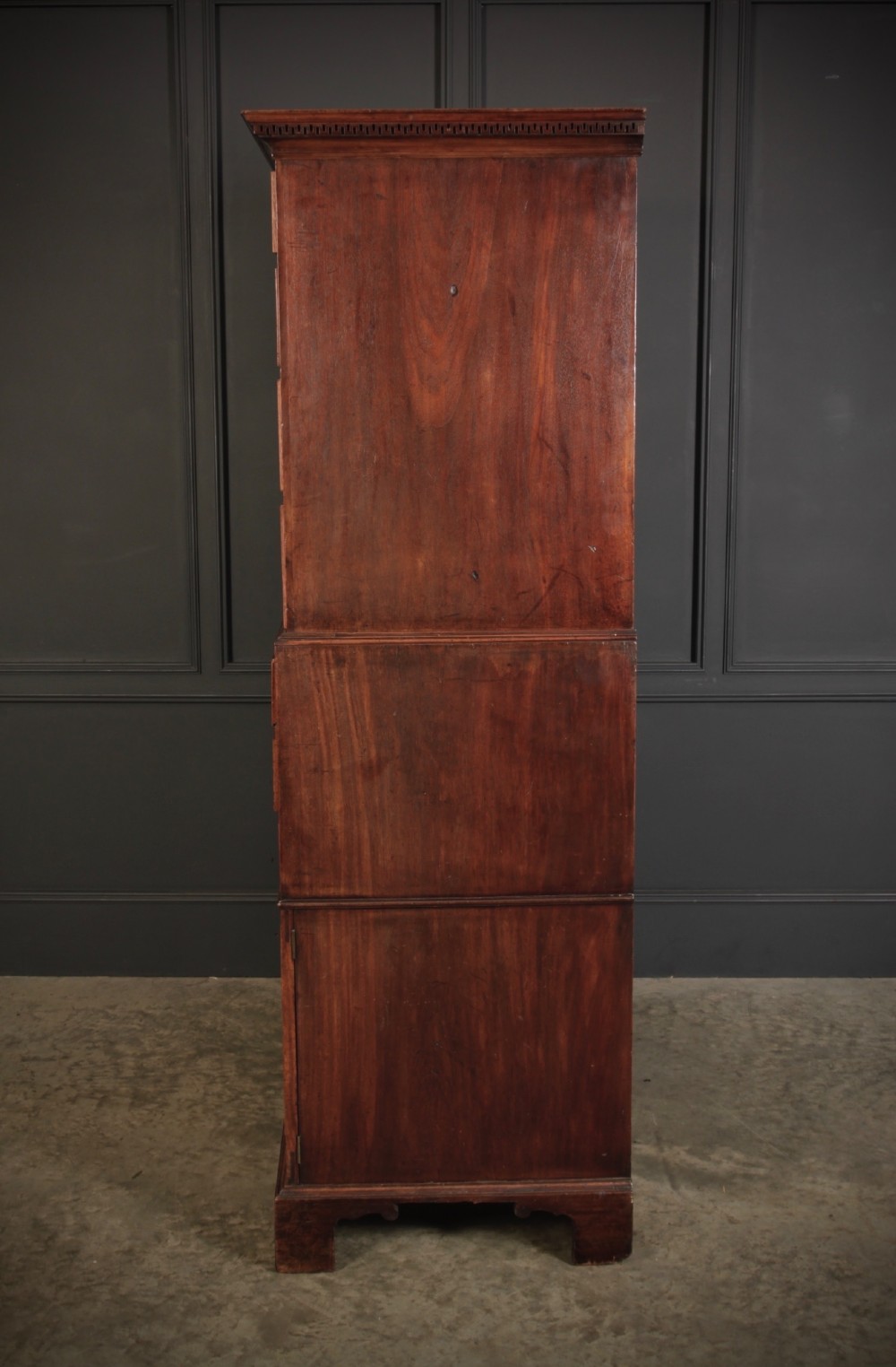 An 18th-century Georgian flame mahogany tallboy chest on chest featuring brass handles, upper drawers, and lower cupboard doors. View X