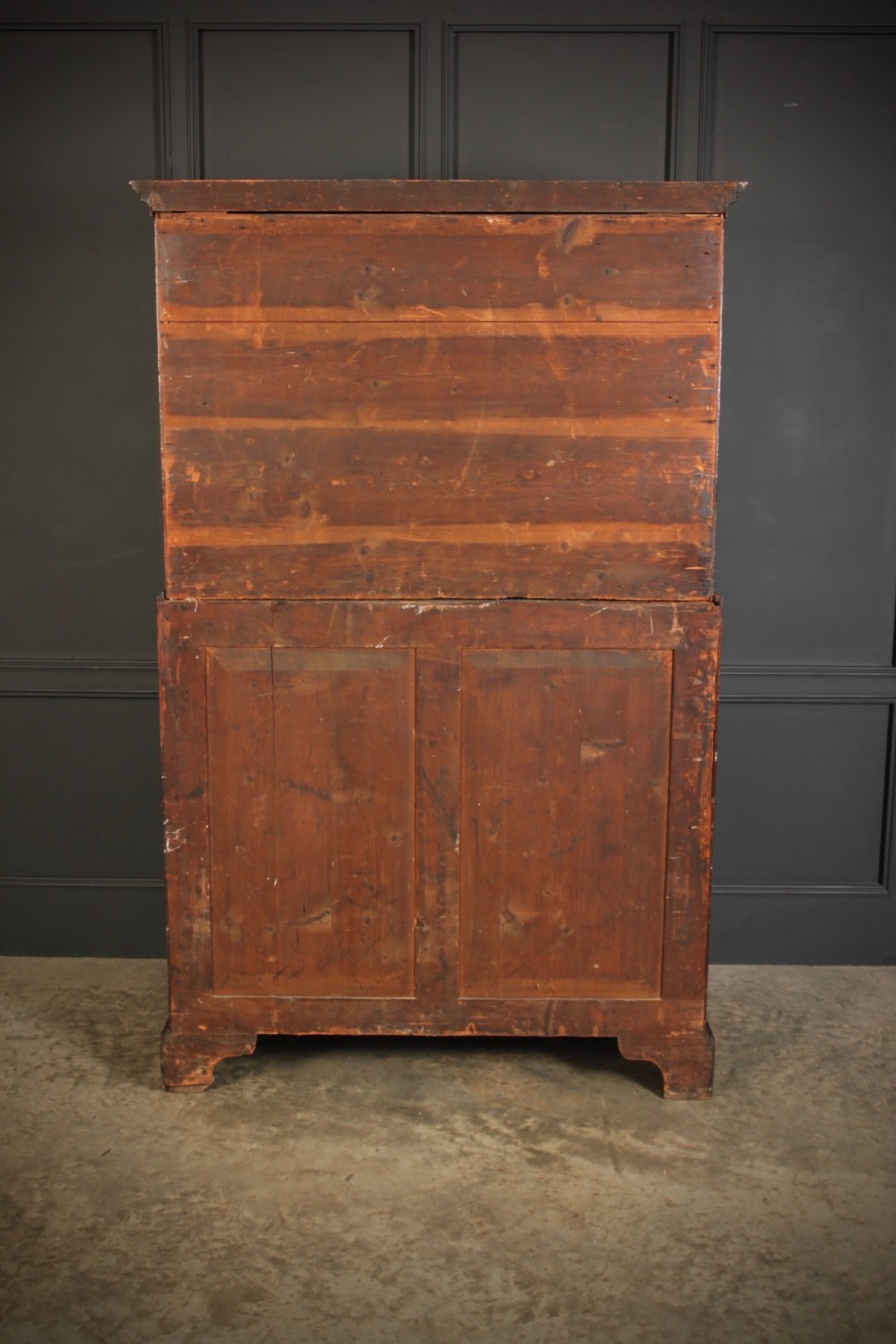 An 18th-century Georgian flame mahogany tallboy chest on chest featuring brass handles, upper drawers, and lower cupboard doors. View XI