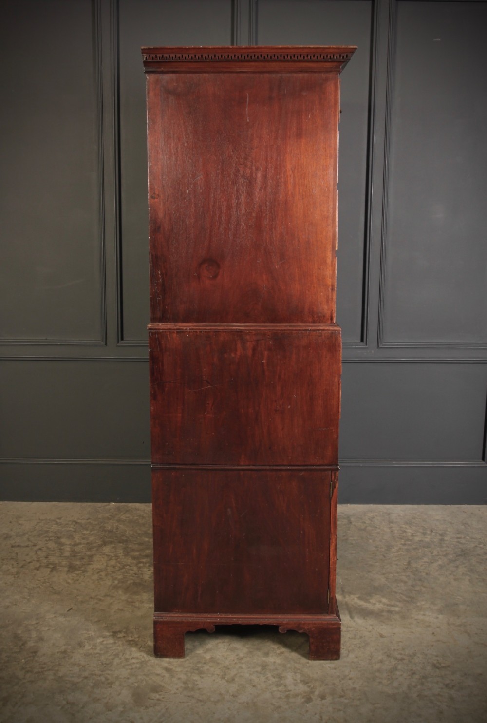 An 18th-century Georgian flame mahogany tallboy chest on chest featuring brass handles, upper drawers, and lower cupboard doors. View XII