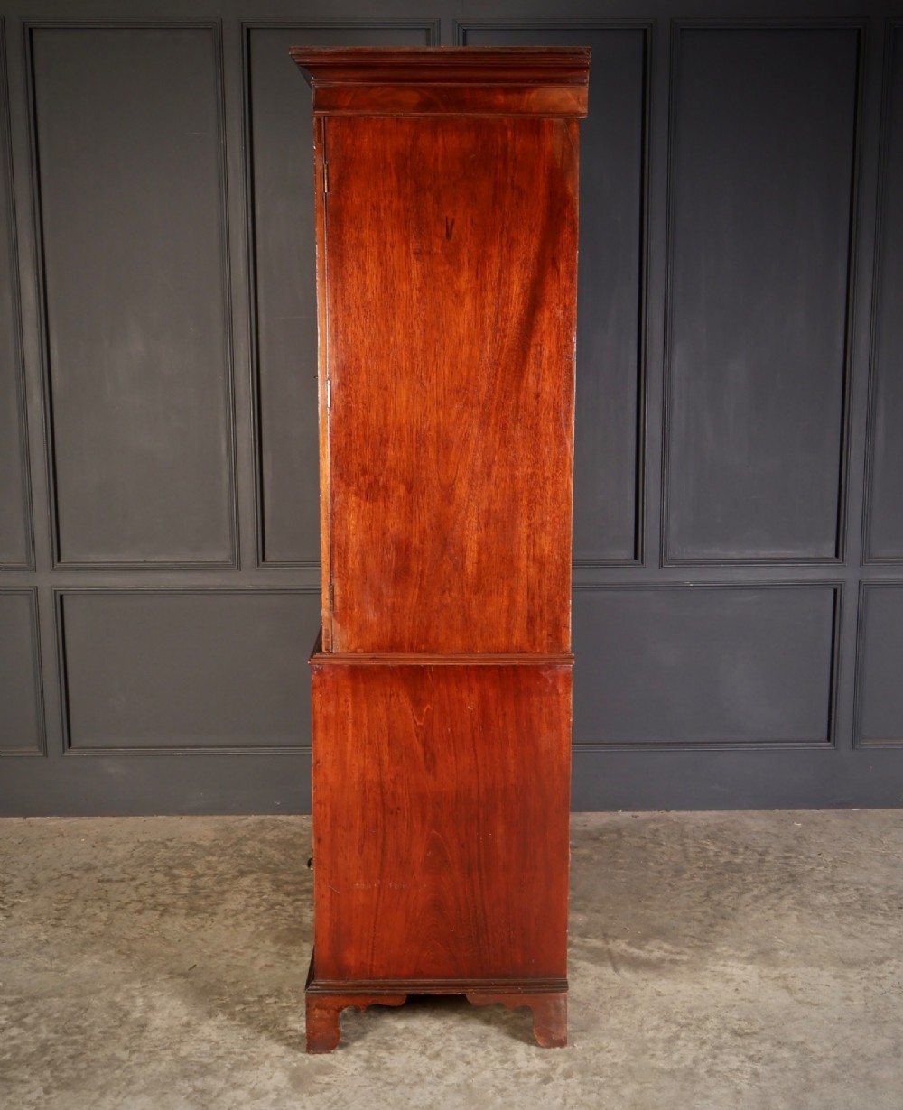 A Georgian mahogany linen press featuring botanical marquetry inlay on upper double doors over four lower drawers with brass handles. View VIII