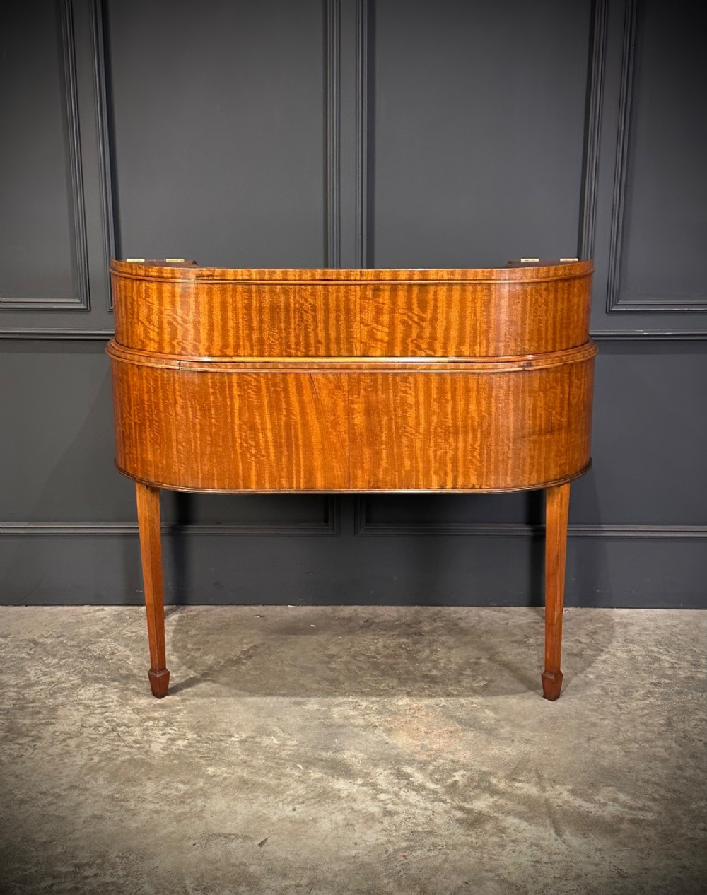 An inlaid mahogany Carlton House writing desk featuring a curved gallery with small drawers and cupboards above a green leather writing surface and square tapered legs. View XI