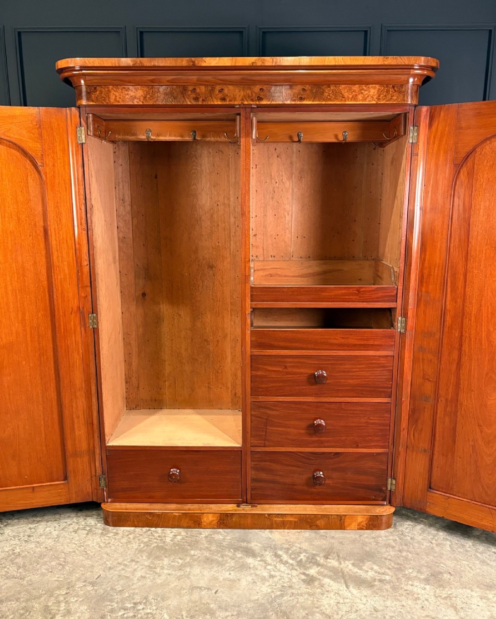 A Victorian double-door wardrobe crafted from figured burr walnut featuring arched door panels and a rounded moulded cornice. View II
