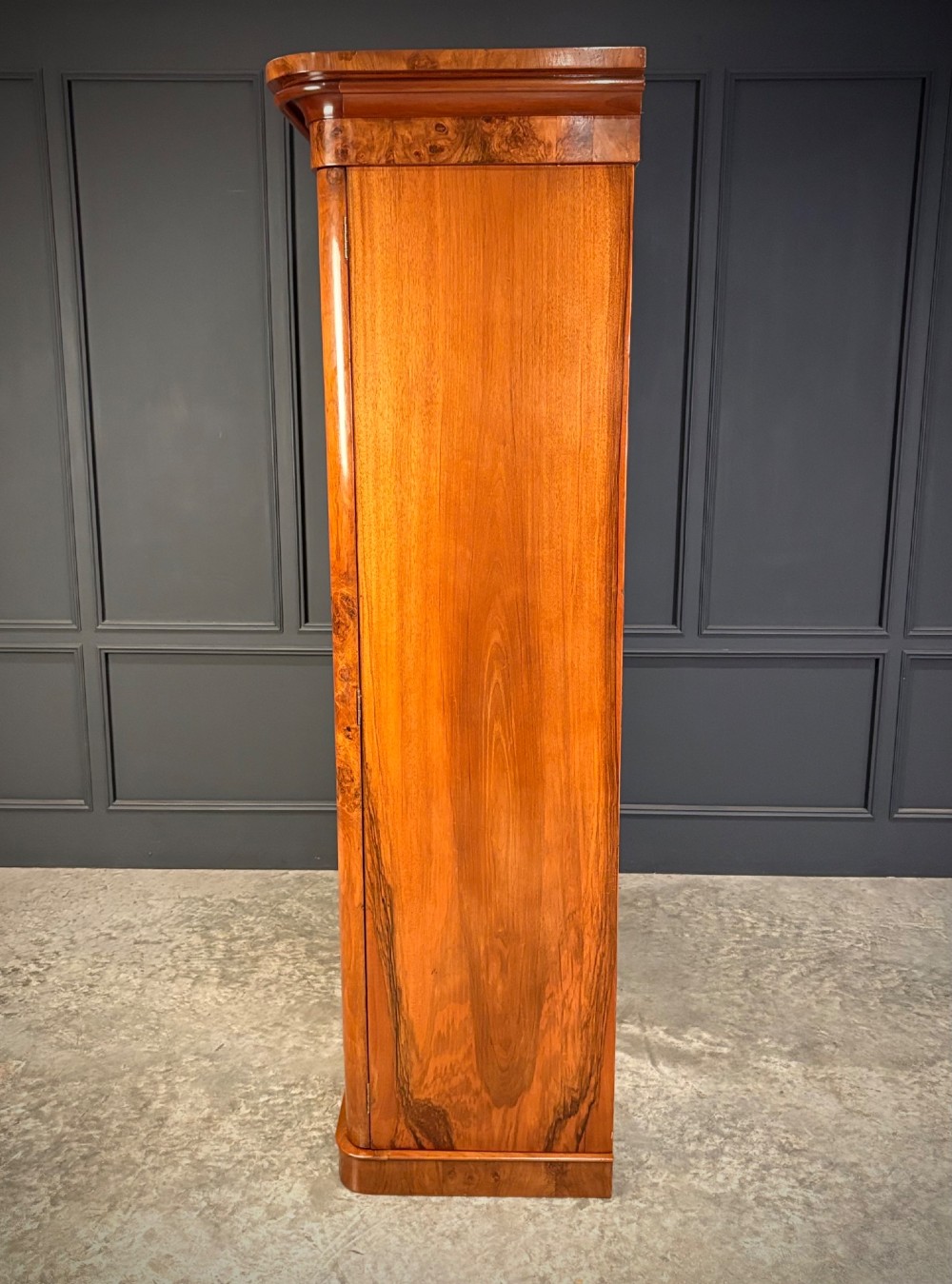 A Victorian double-door wardrobe crafted from figured burr walnut featuring arched door panels and a rounded moulded cornice. View III