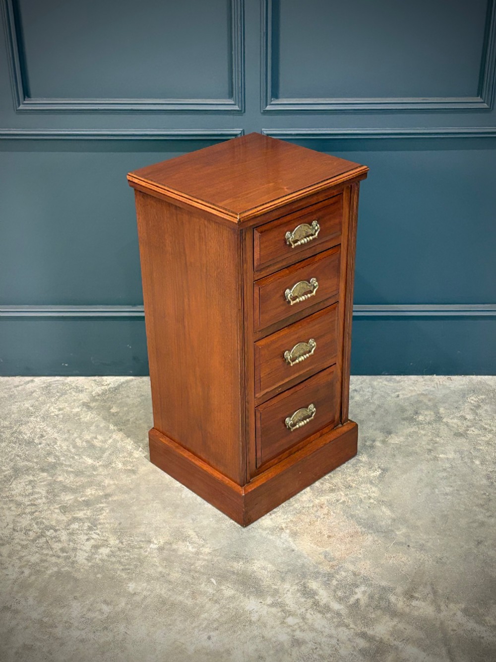 A pair of matching Victorian walnut bedside chests featuring four drawers each, brass drop handles, and a solid plinth base. View III