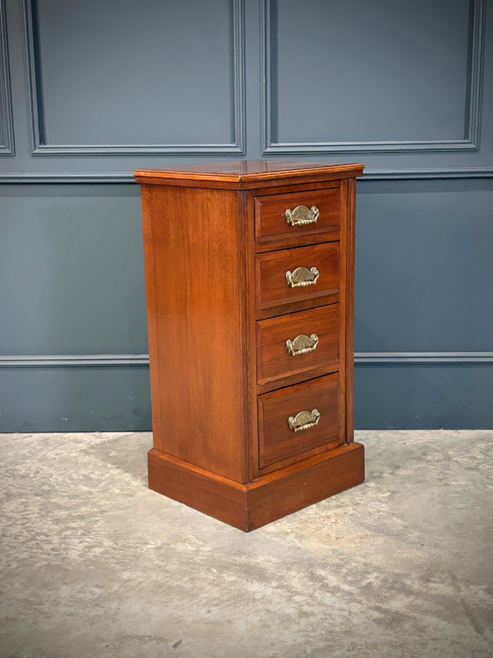 A pair of matching Victorian walnut bedside chests featuring four drawers each, brass drop handles, and a solid plinth base. View IV