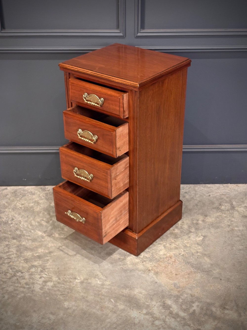 A pair of matching Victorian walnut bedside chests featuring four drawers each, brass drop handles, and a solid plinth base. View VIII