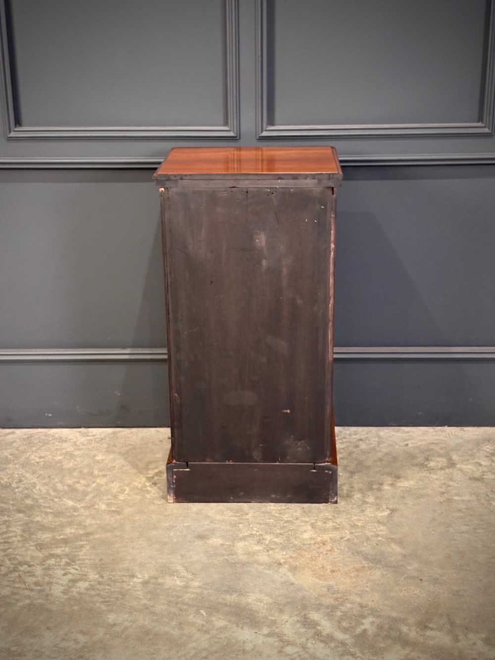A pair of matching Victorian walnut bedside chests featuring four drawers each, brass drop handles, and a solid plinth base. View X