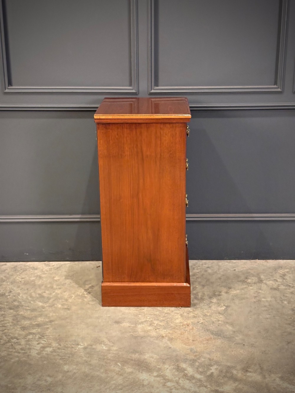 A pair of matching Victorian walnut bedside chests featuring four drawers each, brass drop handles, and a solid plinth base. View XI