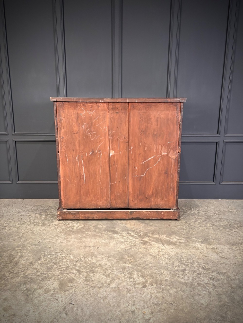 A Victorian mahogany chest of drawers with a two-over-three drawer arrangement, turned wooden knobs, rounded front corners, and a solid plinth base. View X