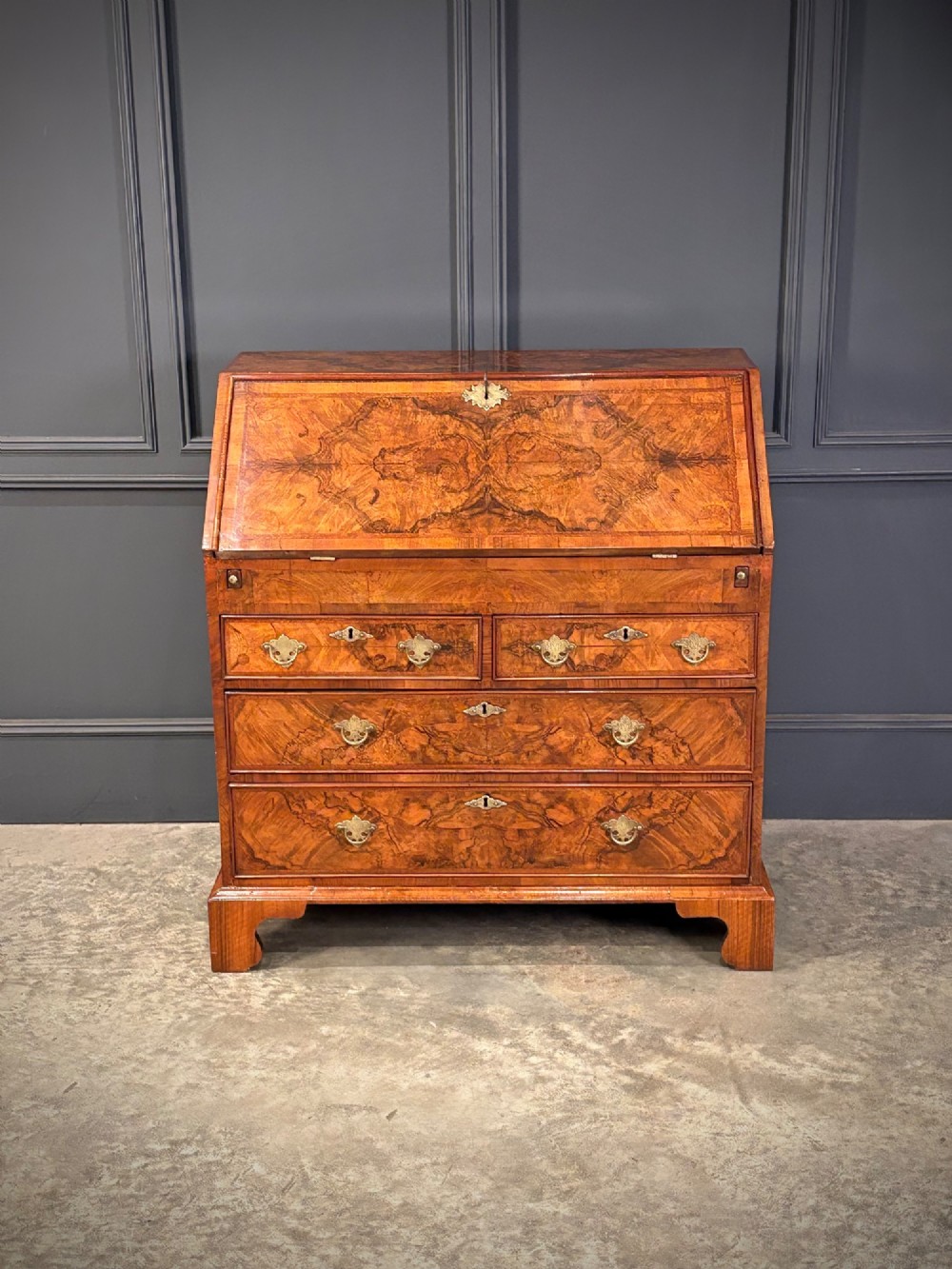 A Queen Anne style writing bureau crafted from figured walnut with a slant front writing flap above two short and two long drawers. View III