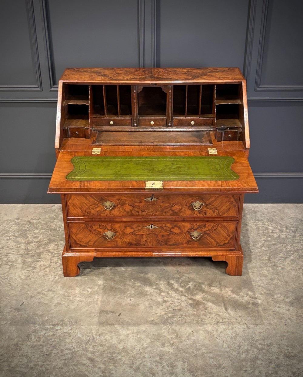 A Queen Anne style writing bureau crafted from figured walnut with a slant front writing flap above two short and two long drawers. View IV