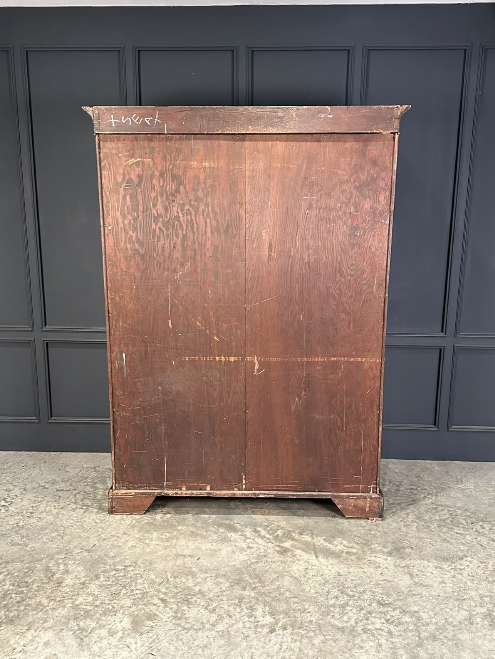 A tall Georgian style mahogany double wardrobe featuring flame mahogany door panels, a moulded cornice, and bracket feet. View IV