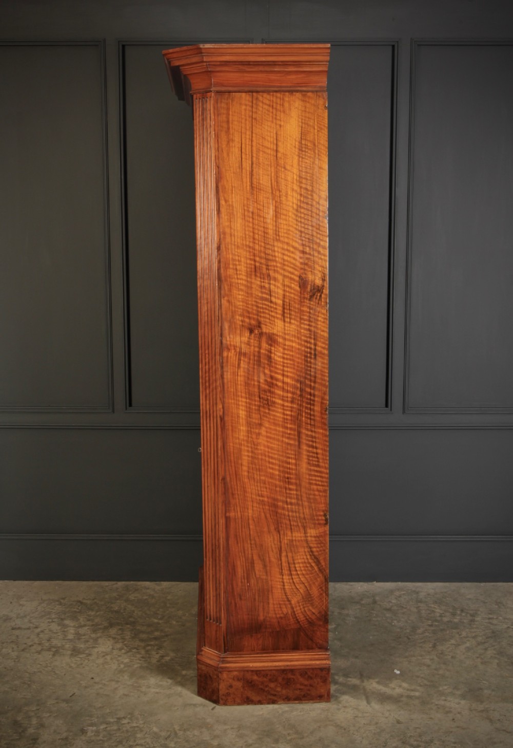 A tall Victorian burr walnut bookcase featuring open upper shelving over a double-door lower cupboard with fluted side pilasters. View XIII