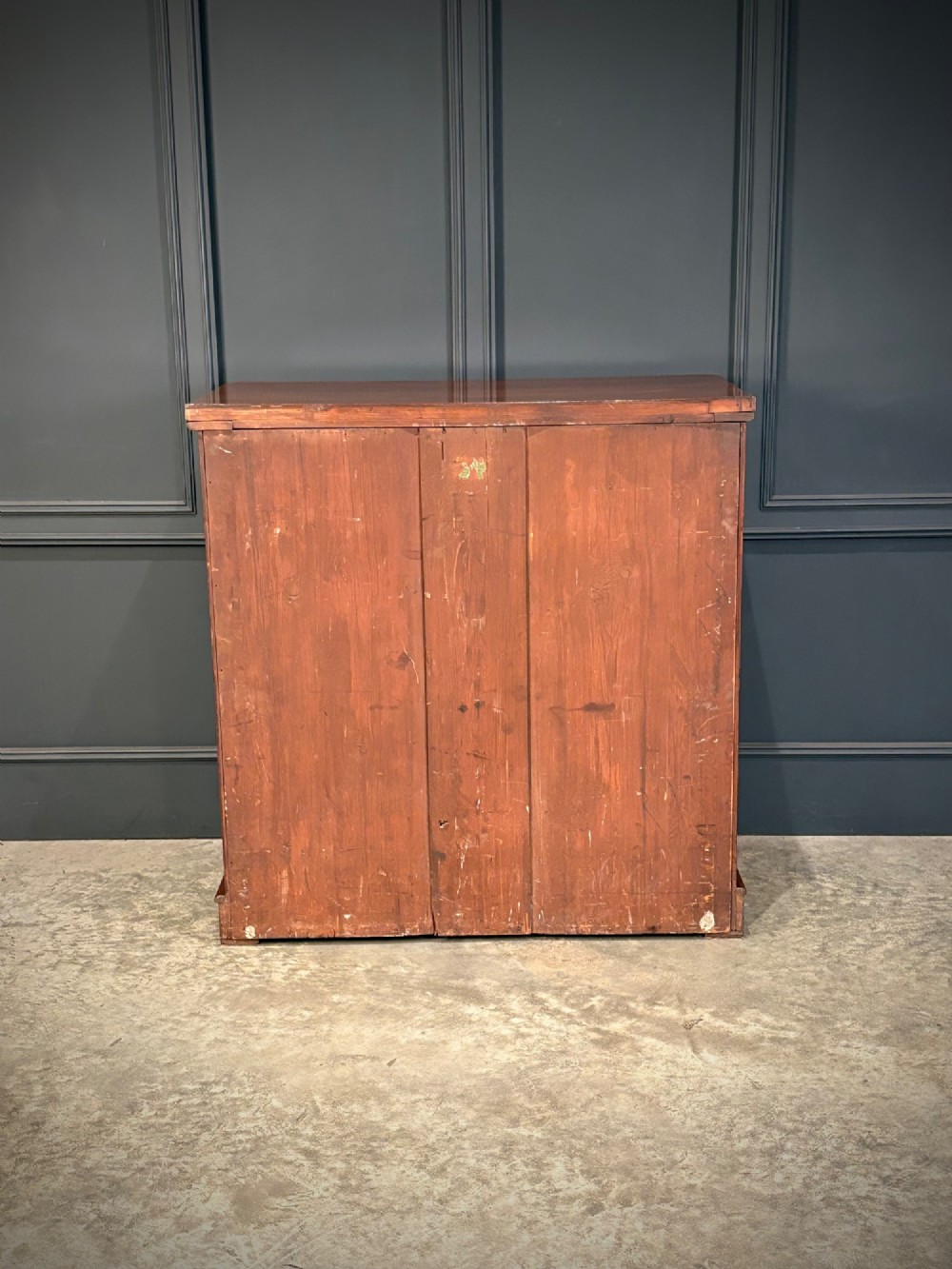 A Victorian mahogany chest of drawers with two short drawers over three long drawers, featuring turned wooden handles and a solid plinth base. View IX