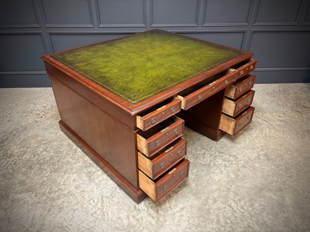 A large Victorian mahogany partners desk with a green leather inset top surface and twin pedestals fitted with wooden drawer pulls. View IV