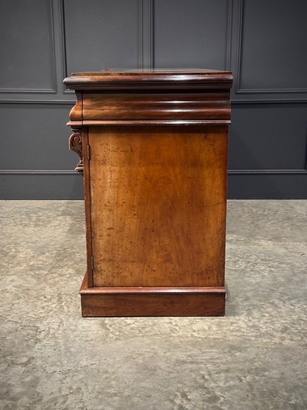 A Victorian mahogany four-door breakfront sideboard featuring arched panel doors, carved support brackets, and a long flat top surface. View XIII